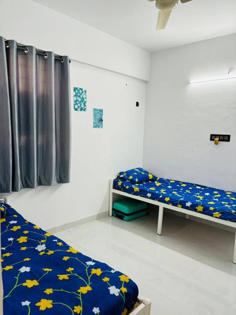 Twin Bed Arrangement with Floral Linen - Bhati Boys PG Warje Pune